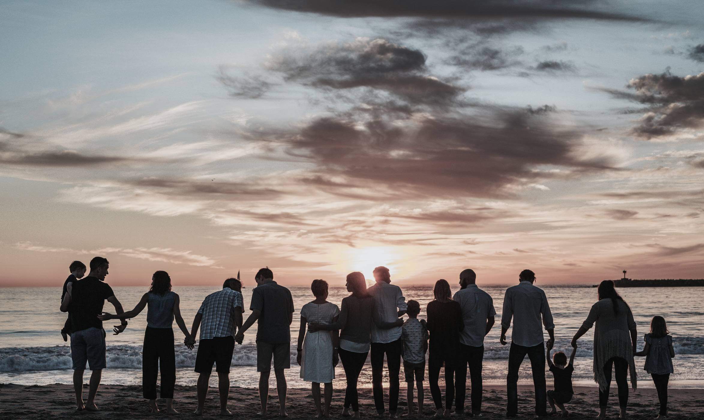 People watching the sunset from a beach